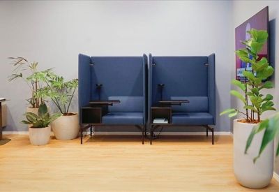 Two private blue acoustic privacy booths for individual work or calls.