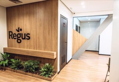 Modern reception area with wood paneling and indoor plants.