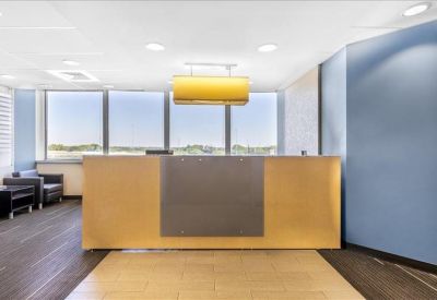 Professional reception area featuring a wood-panelled desk and blue accent wall.