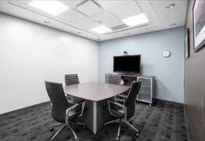 Modern square meeting room with four chairs and a wall-mounted TV.