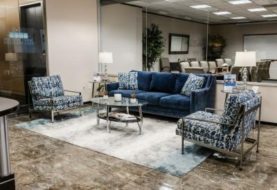 Inviting waiting area with blue plush seating and a glass coffee table.