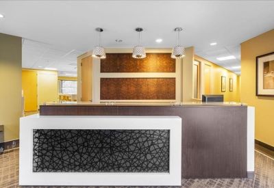 Reception desk featuring a dark wood finish and decorative textured white panel.