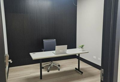 Private office featuring a black slatted accent wall and minimalist desk.