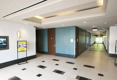 Modern building lobby and reception area with polished tile floors and recessed ceiling lighting.