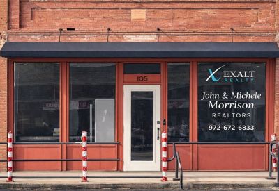 Exterior facade of Ten On The Bricks at 105, North 4th Street featuring red brick and large display windows.