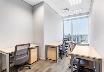 Three-person internal office suite with light wood desks and ergonomic chairs.