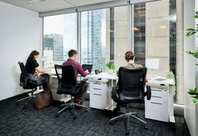 Three-person private office with ergonomic chairs and floor-to-ceiling windows overlooking the city.