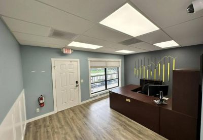 Reception desk view showing the entrance door and decorative wall graphics.