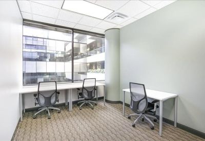 Shared office suite for three with large windows and ergonomic chairs.