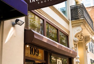 Exterior view of the entrance and branded flag at 109, West 25th Street.