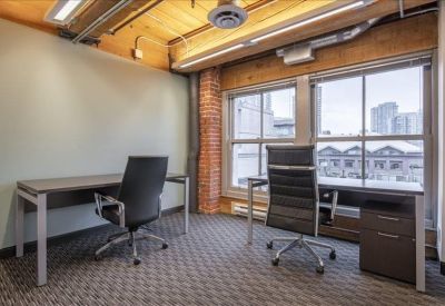 Private two-person office with large windows and wooden ceiling.