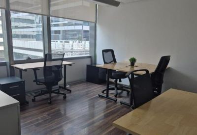 Sunny private office suite with wooden floors and city views.