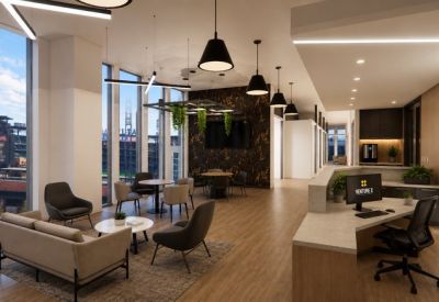 Bright reception area with a wood-fronted desk and comfortable waiting lounge.