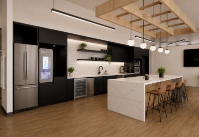 Modern kitchen and breakroom featuring a large marble island and black cabinetry.