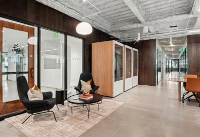 Vibrant reception and waiting area with stylish armchairs and modern wood-slat wall accents.