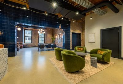 Private office suite with three large windows and multiple desks.