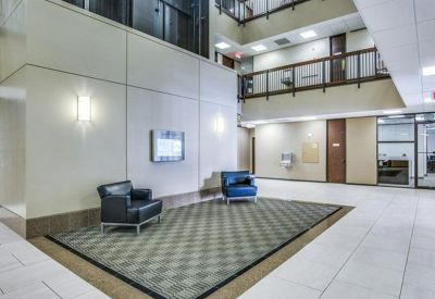 Spacious multi-story lobby with polished floors and seating areas.