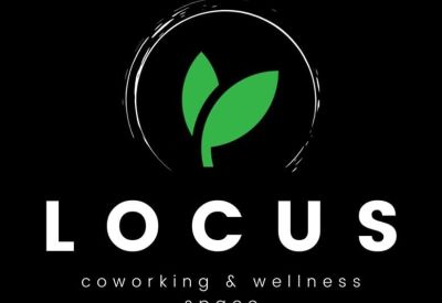 Bright shared office space with three individual desks and large windows.