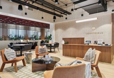 Spacious reception area with a wood-slat desk and comfortable lounge seating.