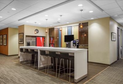 Contemporary breakout cafe area with high-top seating and coffee station.