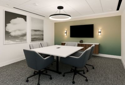 Modern conference room with a white table, teal chairs, and a green ombre feature wall.