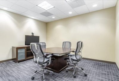 Modern communal kitchen and break area with wooden cabinetry and island seating.