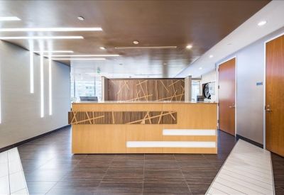 Professional reception desk with wood panelling and contemporary strip lighting.