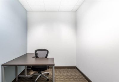 Spacious boardroom with a large conference table and floor-to-ceiling windows.