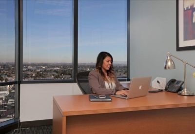 Private office with a large window overlooking the city skyline.
