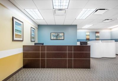 Professional reception desk with a dark wood finish and blue accent wall.