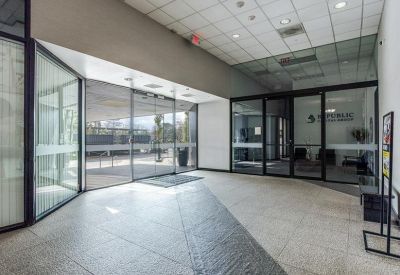 Building lobby entrance with polished stone floors and glass double doors.