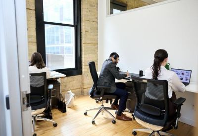 Bright private office suite with ergonomic chairs and large windows.