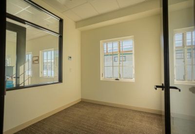 Private office suite with a large window and glass entry door.