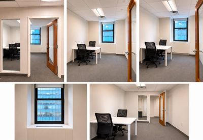 Small office with two desks and large window.