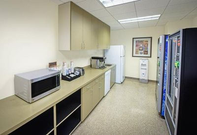 Communal breakroom with microwave, coffee station, and vending machines.