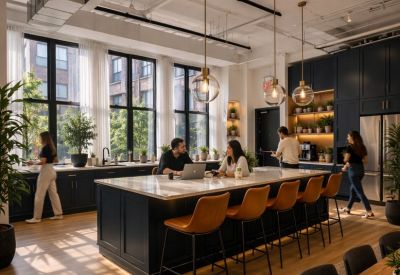 Spacious communal kitchen and dining area at 151, West 26th Street with a large island and warm lighting.