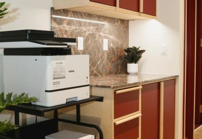 Office utility area with printer and maroon storage cabinets.