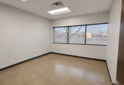 Windowed corner office with natural light and views of local street activity.