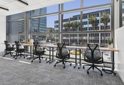 Window-facing workstations with ergonomic chairs and city views.
