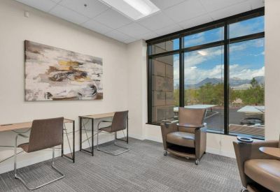 Open-plan lounge area with comfortable armchairs and mountain views.