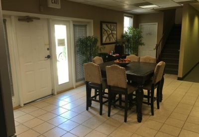 Casual meeting area or breakout space with a high-top dining table and potted plants.
