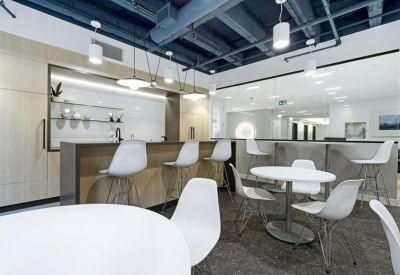 Breakout lounge and cafe area with high-top seating and a sleek kitchenette.