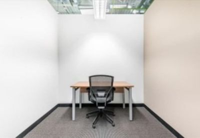 Private internal office suite for one person with white walls and a mesh chair.