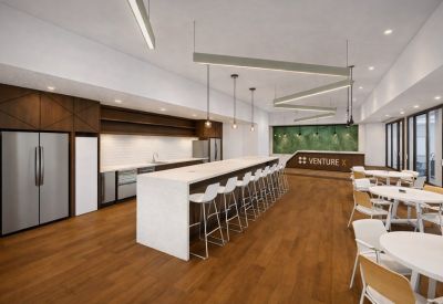 Sleek kitchen area with a long white breakfast bar and wood flooring.