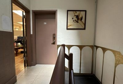 Building hallway entrance leading into the office suite with decorative wall detailing.