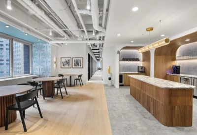 Bright dining and lounge area with a marble cafe counter, wooden archways, and stylish round tables.