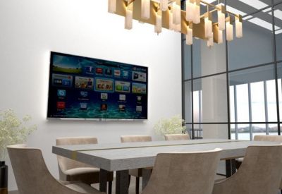 Bright conference room featuring a large concrete table and a contemporary gold light fixture.