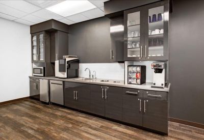 Kitchen area with modern appliances and dark cabinetry.