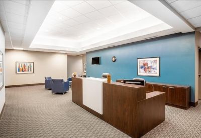 Reception area with front desk and colorful seating.