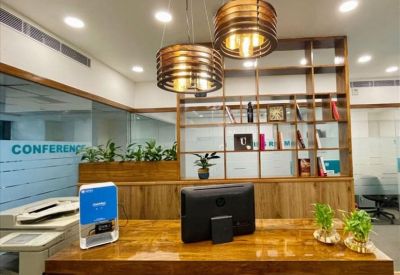 Private office featuring a single desk and ergonomic chair centered in front of a bright window.